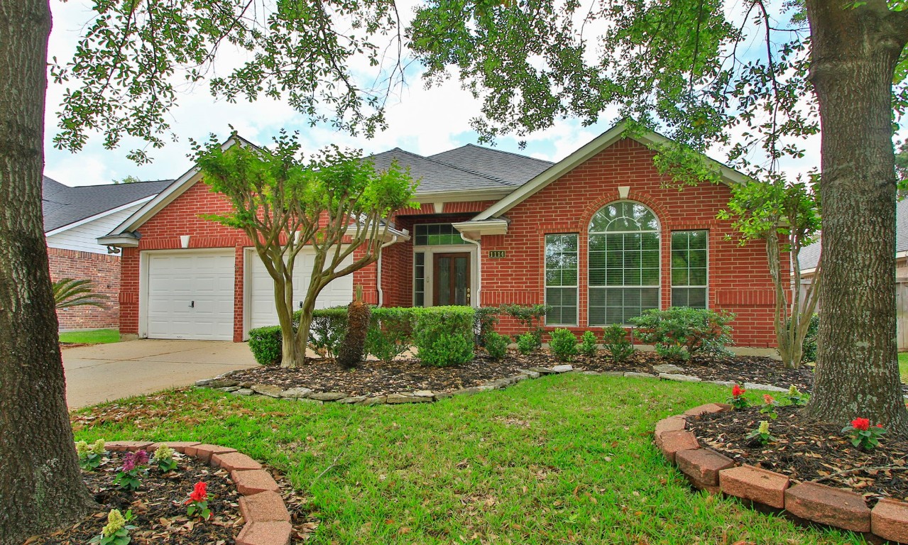 1114 Bringewood Chase Drive Spring, TX 77379 - Photo 2 of 49 a front view of a house with a yard and porch