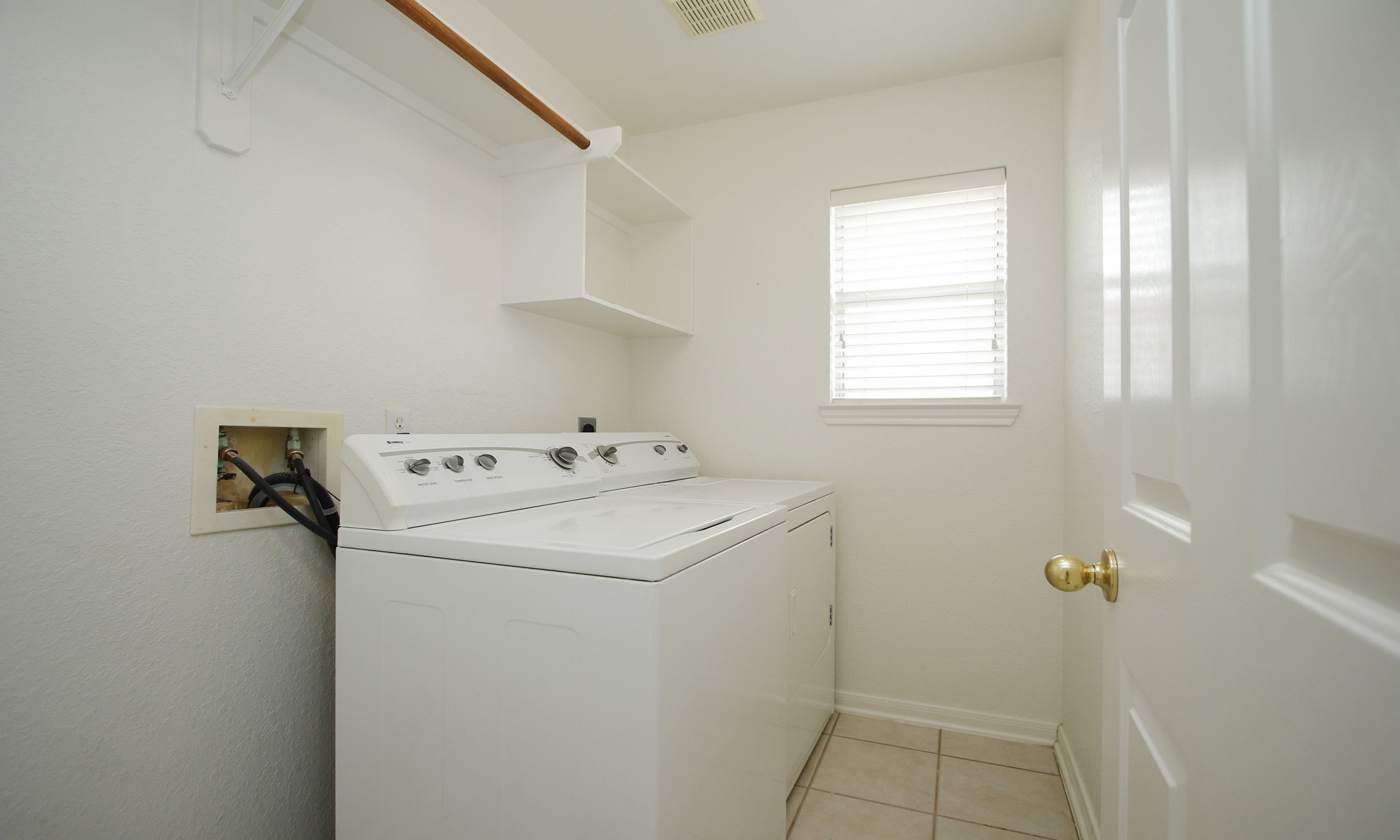1114 Bringewood Chase Drive Spring, TX 77379 - Photo 33 of 44 Laundry room with window and hanging rod.
