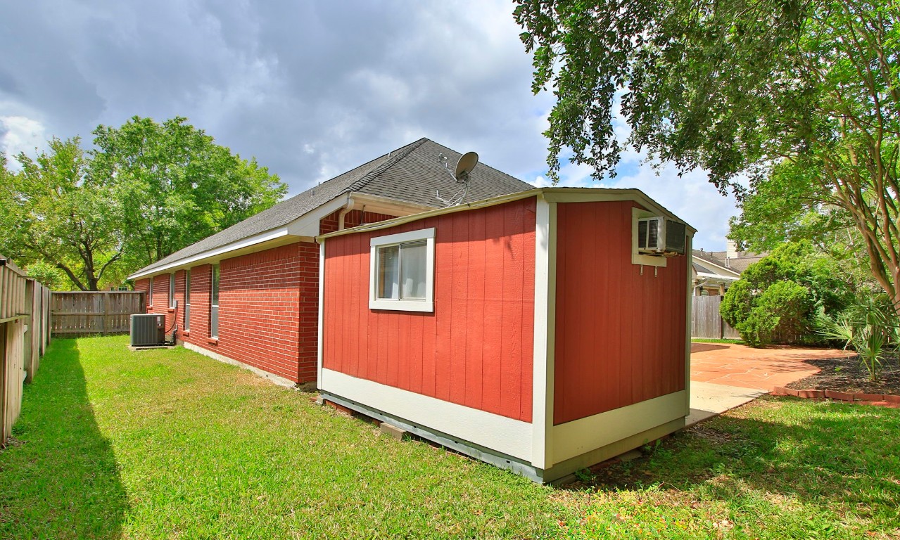 1114 Bringewood Chase Drive Spring, TX 77379 - Photo 42 of 49 a backyard of a house with large trees and brick walls