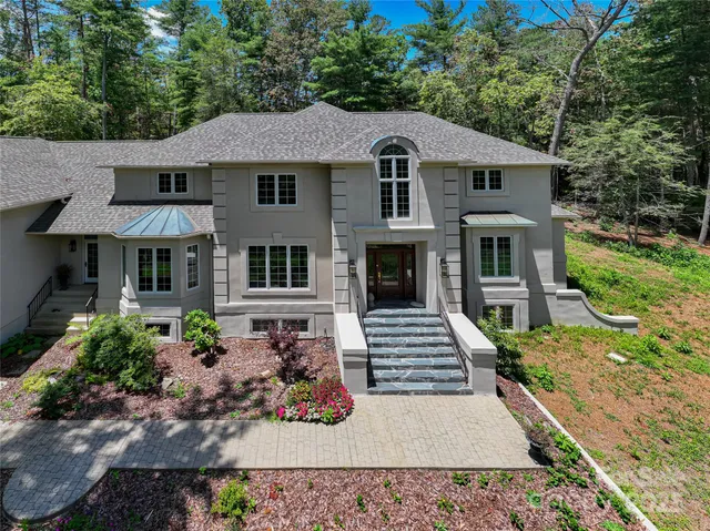 a house with lots of trees in the background