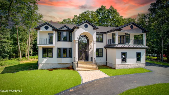 a front view of a house with a yard and garage