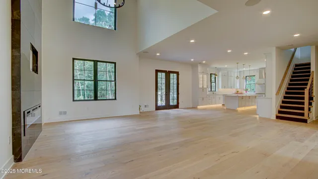 an empty room with wooden floor and a ceiling fan