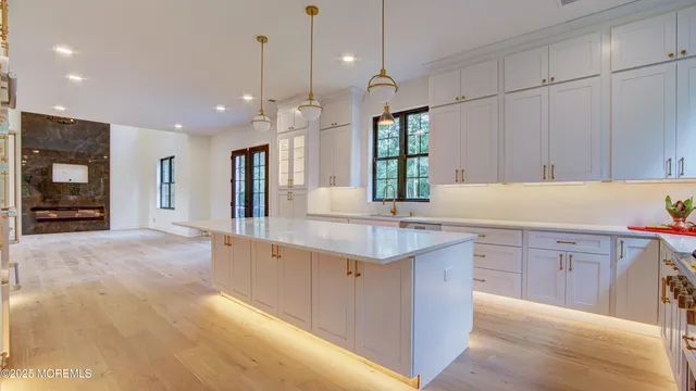 a kitchen with stainless steel appliances granite countertop a sink a stove and a refrigerator