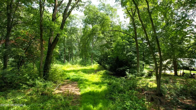 a large kitchen with stainless steel appliances kitchen island granite countertop a refrigerator and a sink