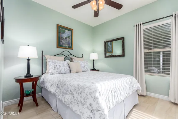 a bedroom with a bed and a lamp on table