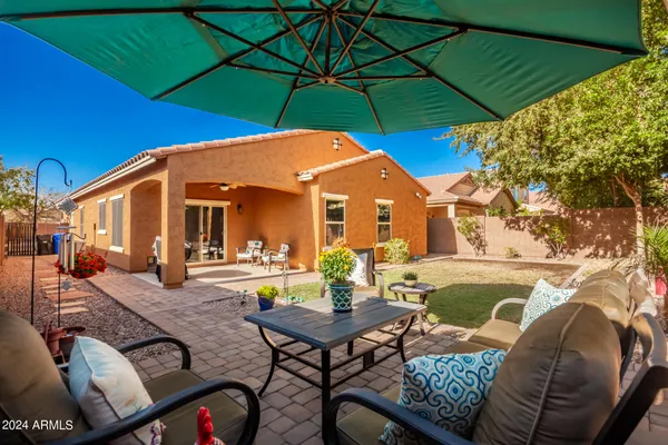 a view of a house with backyard and sitting area