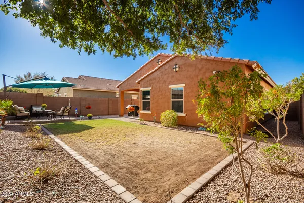 a view of a house with a backyard