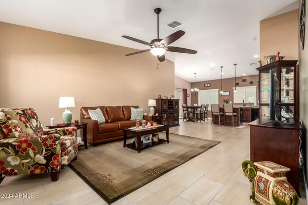 a living room with furniture and a chandelier