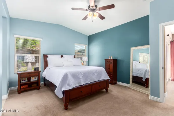 a spacious bedroom with a bed and a window