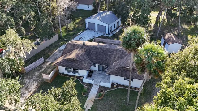 an aerial view of a house with garden space and street view