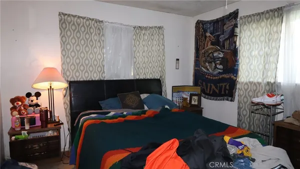 a bedroom with a bed and a lamp