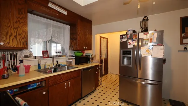 a kitchen with stainless steel appliances a refrigerator and a sink