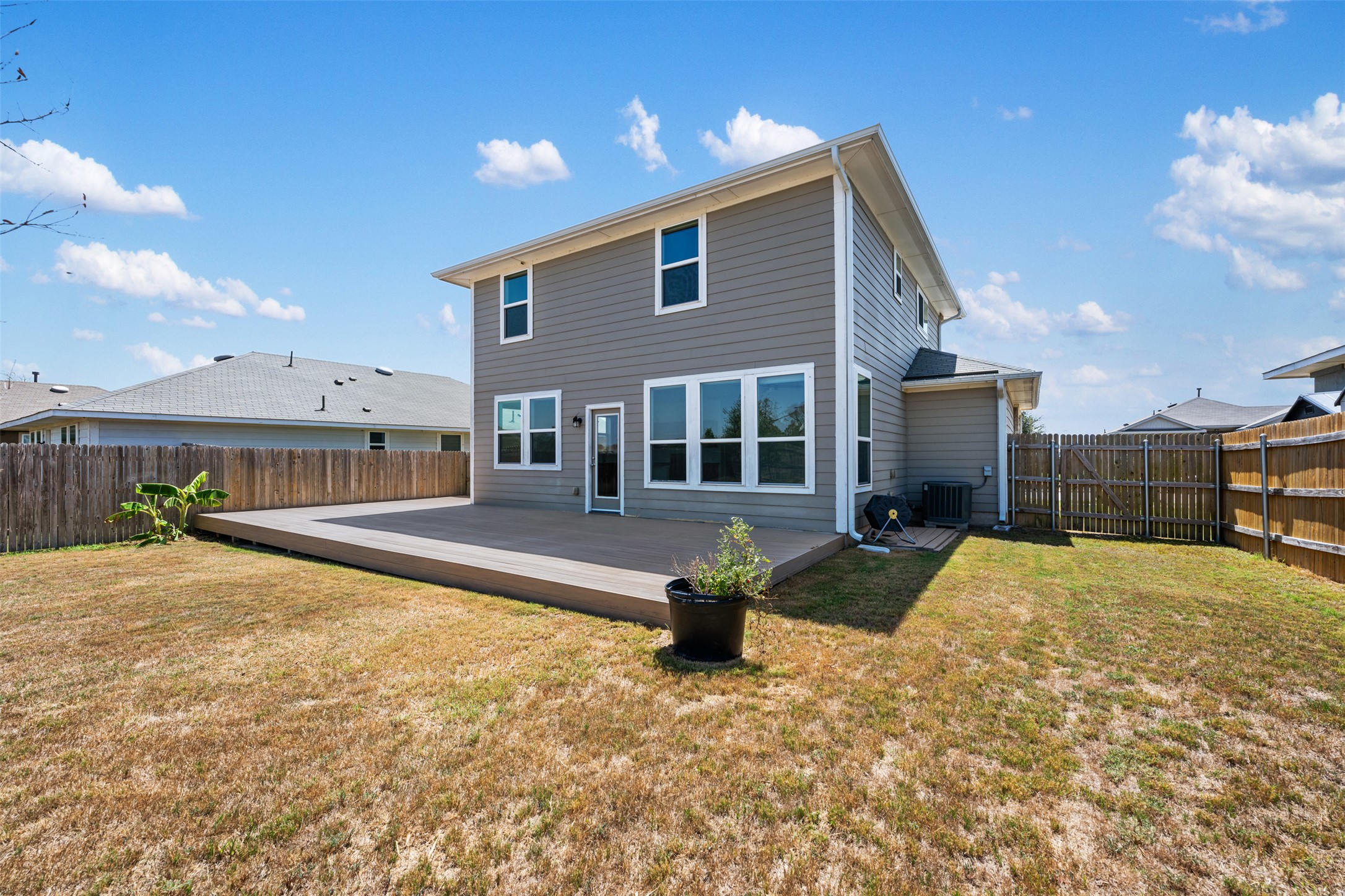 104 Cates Cove Elgin, TX 78621 - Photo 28 of 31 A huge backyard composite deck under clear skies.