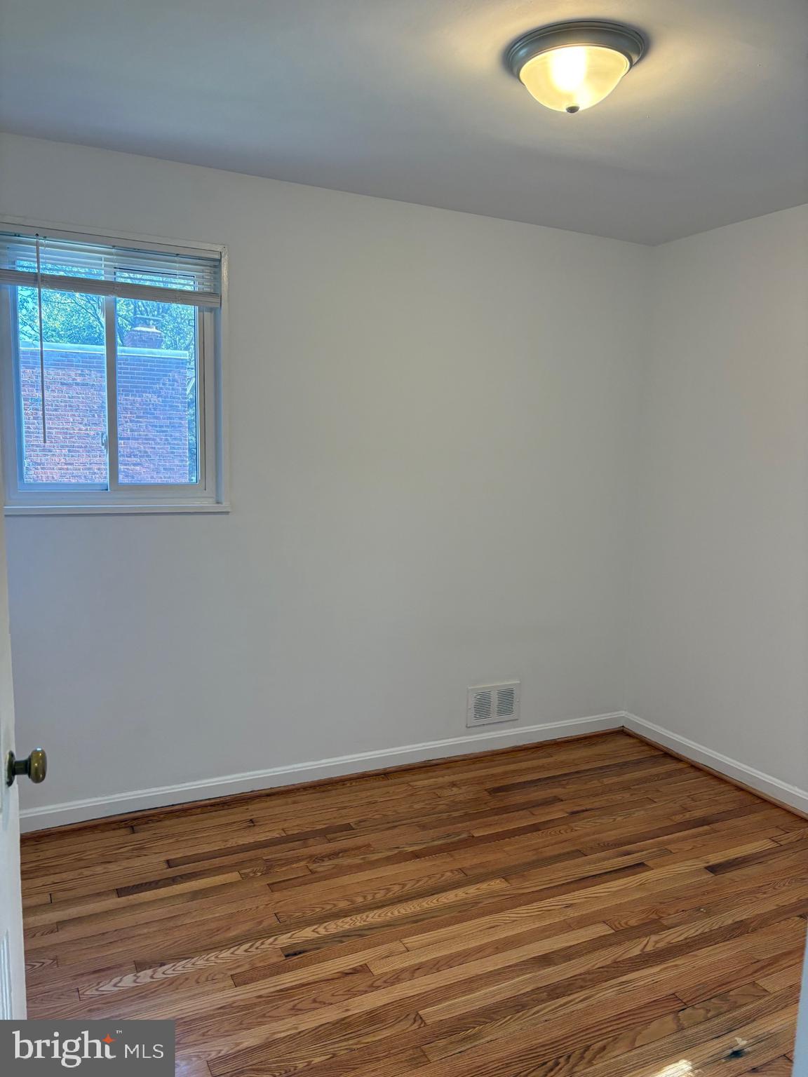3222 13th Road South Arlington, VA 22204 - Photo 8 of 18 an empty room with wooden floor and windows