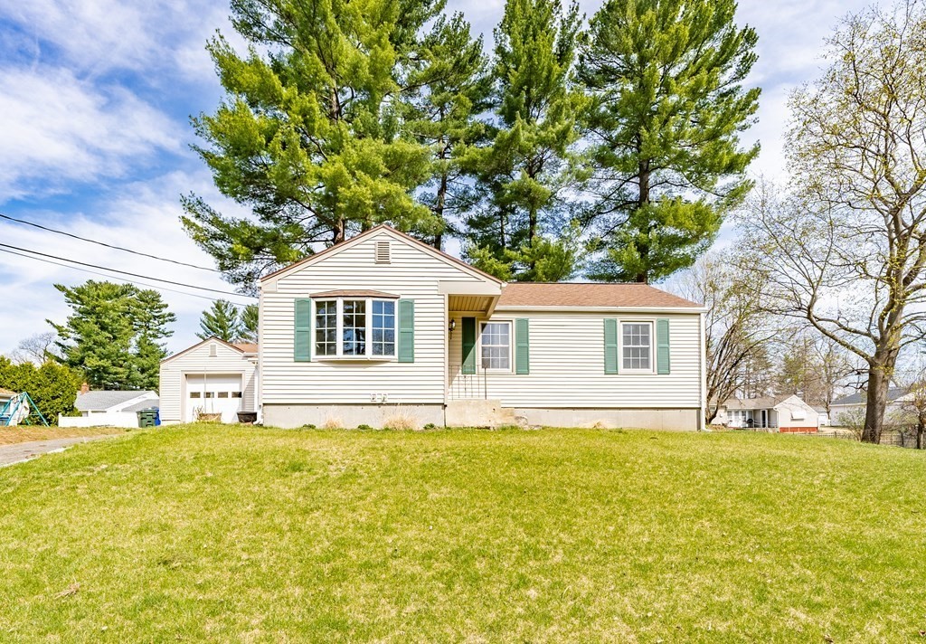 16 Middlebrook Drive Springfield, MA 01129 - Photo 2 of 30 a front view of a house with a garden and tree