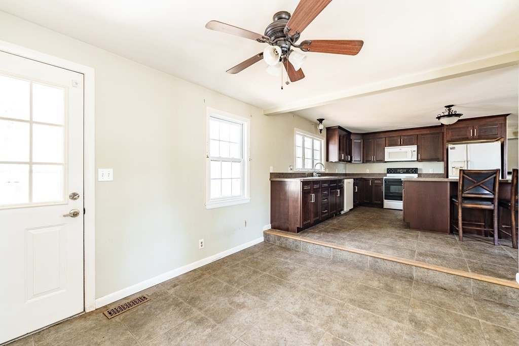 16 Middlebrook Drive Springfield, MA 01129 - Photo 6 of 30 a view of a kitchen with furniture a ceiling fan and windows