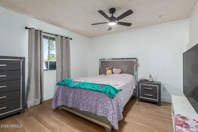 a bedroom with a bed and a large mirror