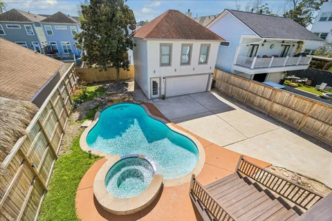 an aerial view of a house with swimming pool and glass doors