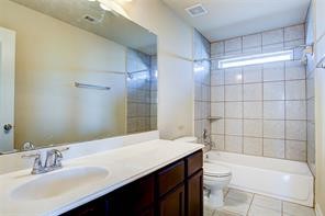 2723 Intrepid Trail Rosenberg, TX 77471 - Photo 25 of 30 The second floor bathroom has tile flooring, built-in cabinets and a tiled tub/shower combo.