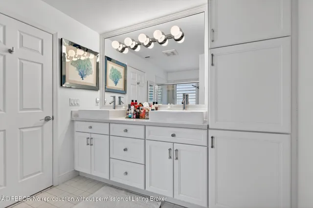 a bathroom with a sink vanity and mirror