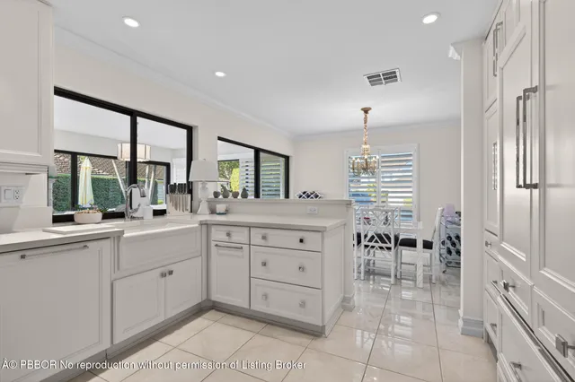 a kitchen with a stove a sink a dining table and chairs