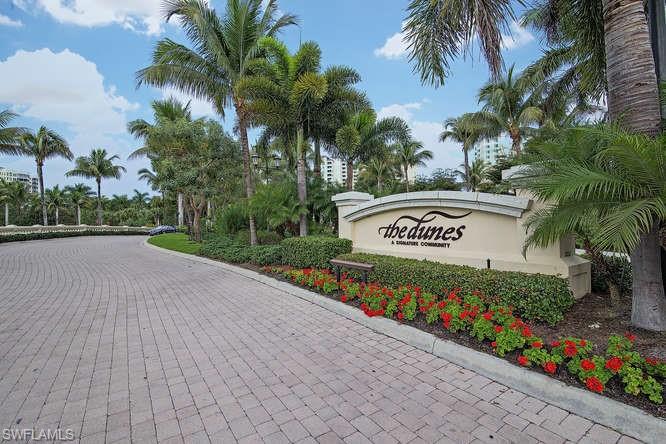 295 Grande Way, Unit 1006 Naples, FL 34110 - Photo 11 of 12 a sign on the side of the road