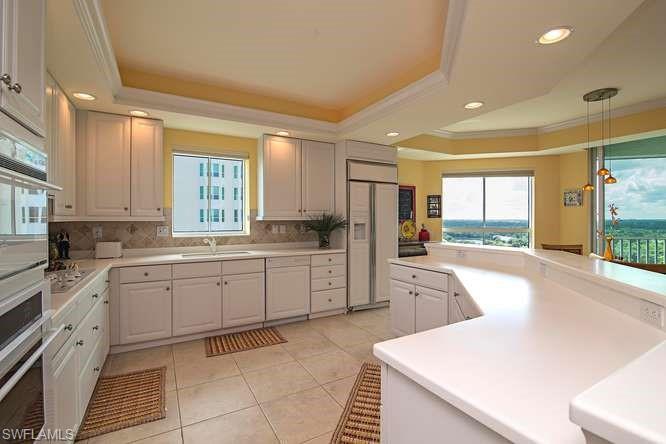 295 Grande Way, Unit 1006 Naples, FL 34110 - Photo 4 of 12 a large kitchen with a large window