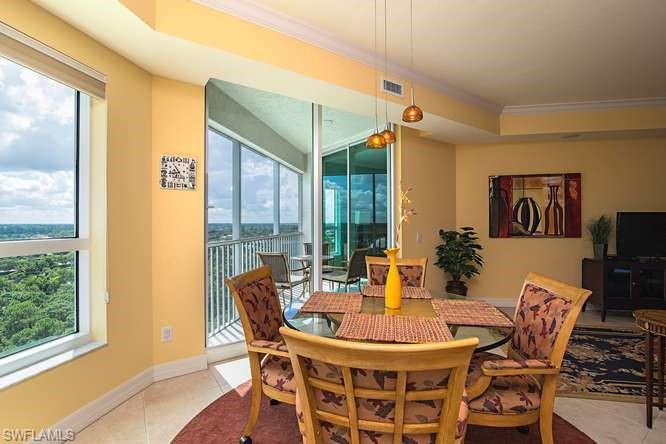 295 Grande Way, Unit 1006 Naples, FL 34110 - Photo 5 of 12 a dining room with furniture and wooden floor