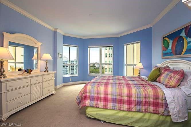 295 Grande Way, Unit 1006 Naples, FL 34110 - Photo 9 of 12 a bedroom with a bed and a large window