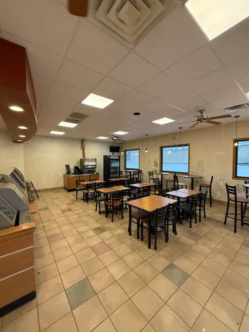 a living room with lots of furniture and kitchen view