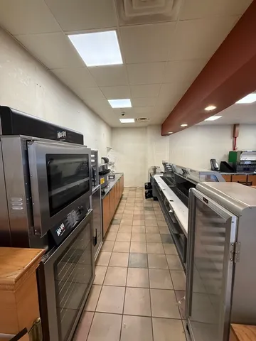 a kitchen with stainless steel appliances a stove a sink and a microwave