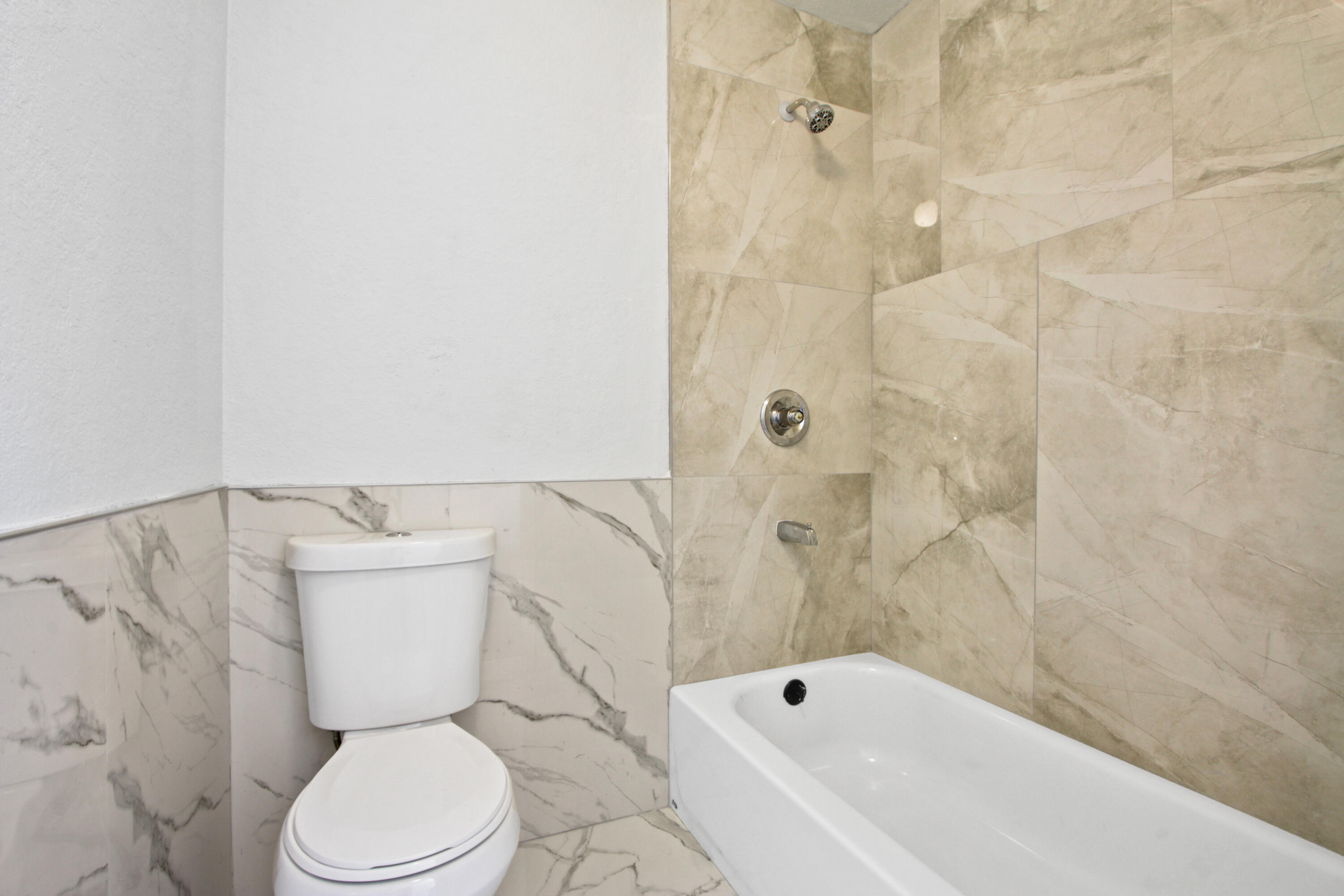 9542 Ball Road, Unit 1 Anaheim, CA 92804 - Photo 14 of 24 a bathroom with a toilet and a bathtub