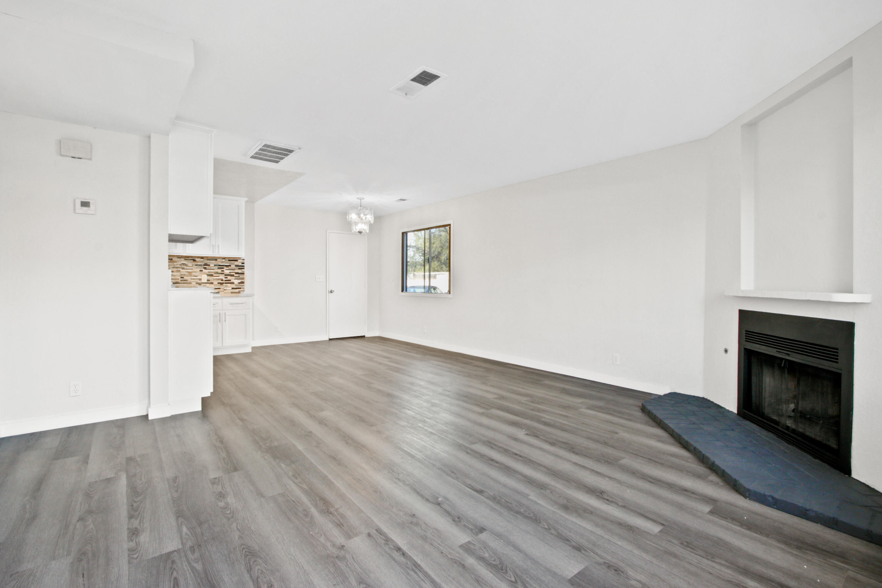 9542 Ball Road, Unit 1 Anaheim, CA 92804 - Photo 7 of 24 a view of empty room with wooden floor and fireplace