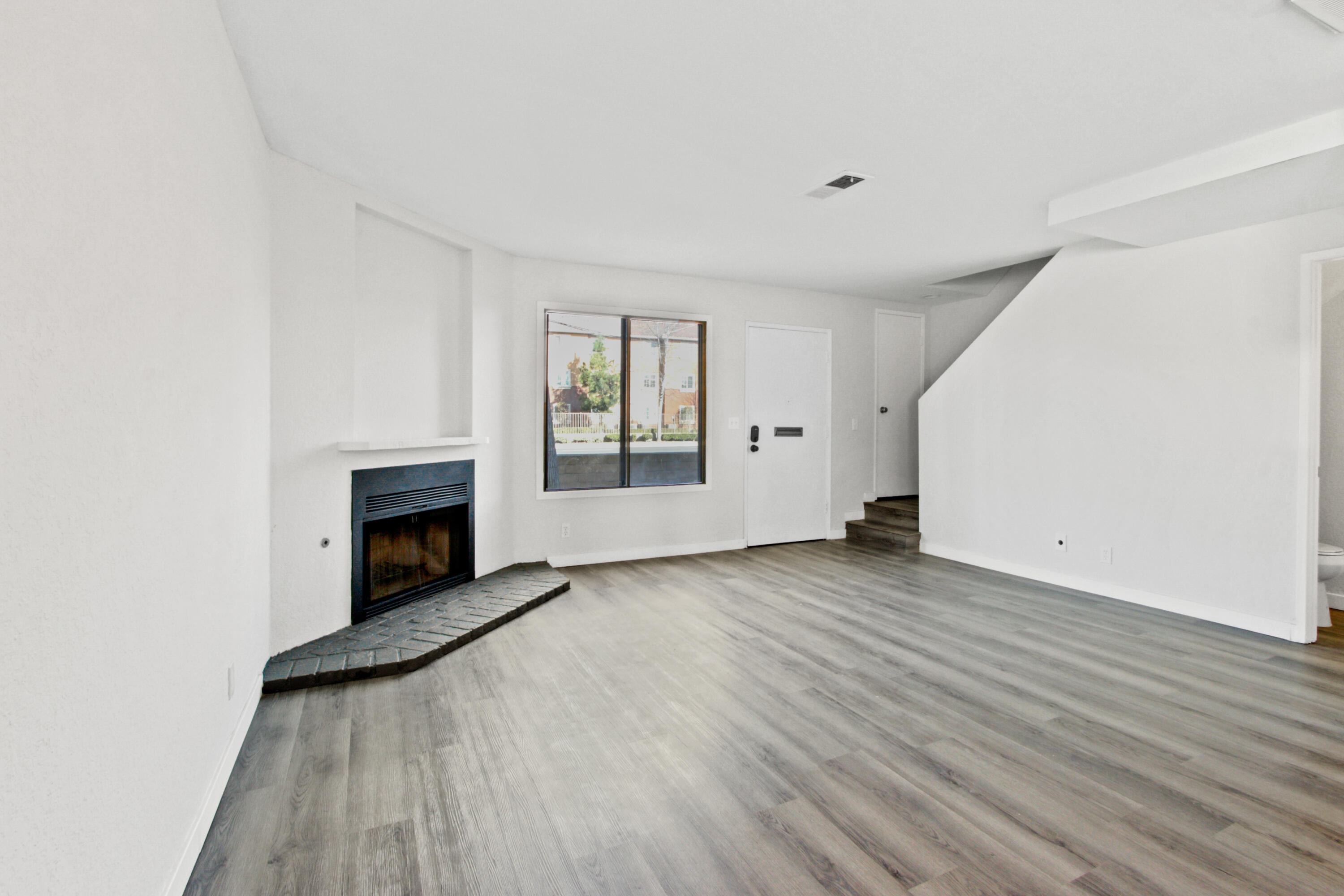 9542 Ball Road, Unit 1 Anaheim, CA 92804 - Photo 8 of 24 a view of empty room with wooden floor and fireplace