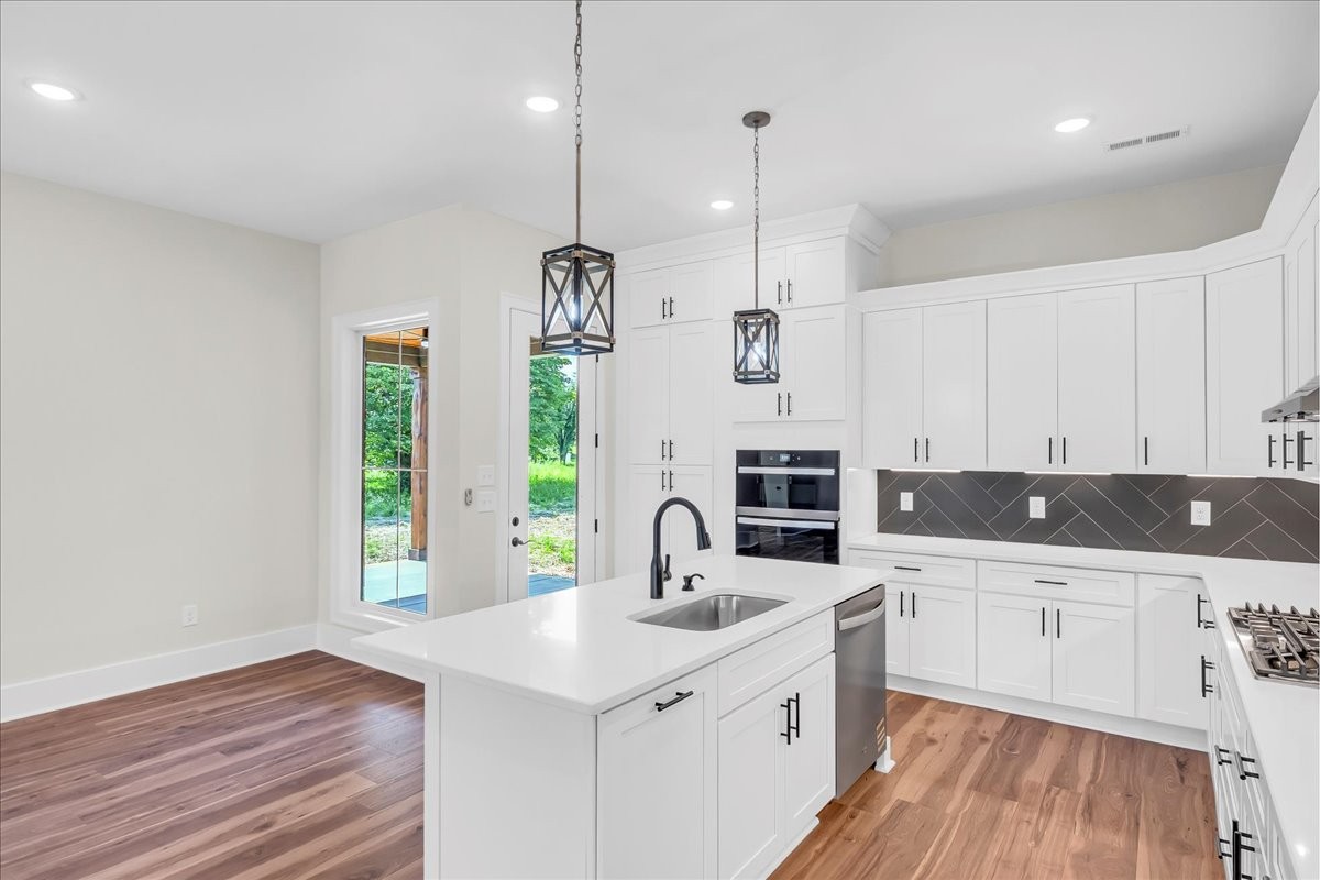 309 Hickory Grove Drive Morrison, TN 37357 - Photo 19 of 50 a kitchen with granite countertop a sink a counter space appliances and cabinets