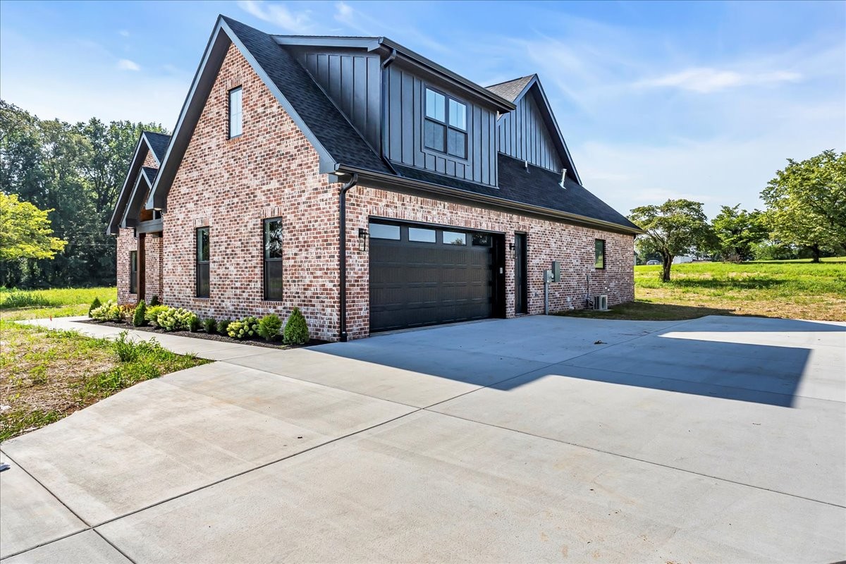 309 Hickory Grove Drive Morrison, TN 37357 - Photo 3 of 50 a front view of a house with a yard and garage