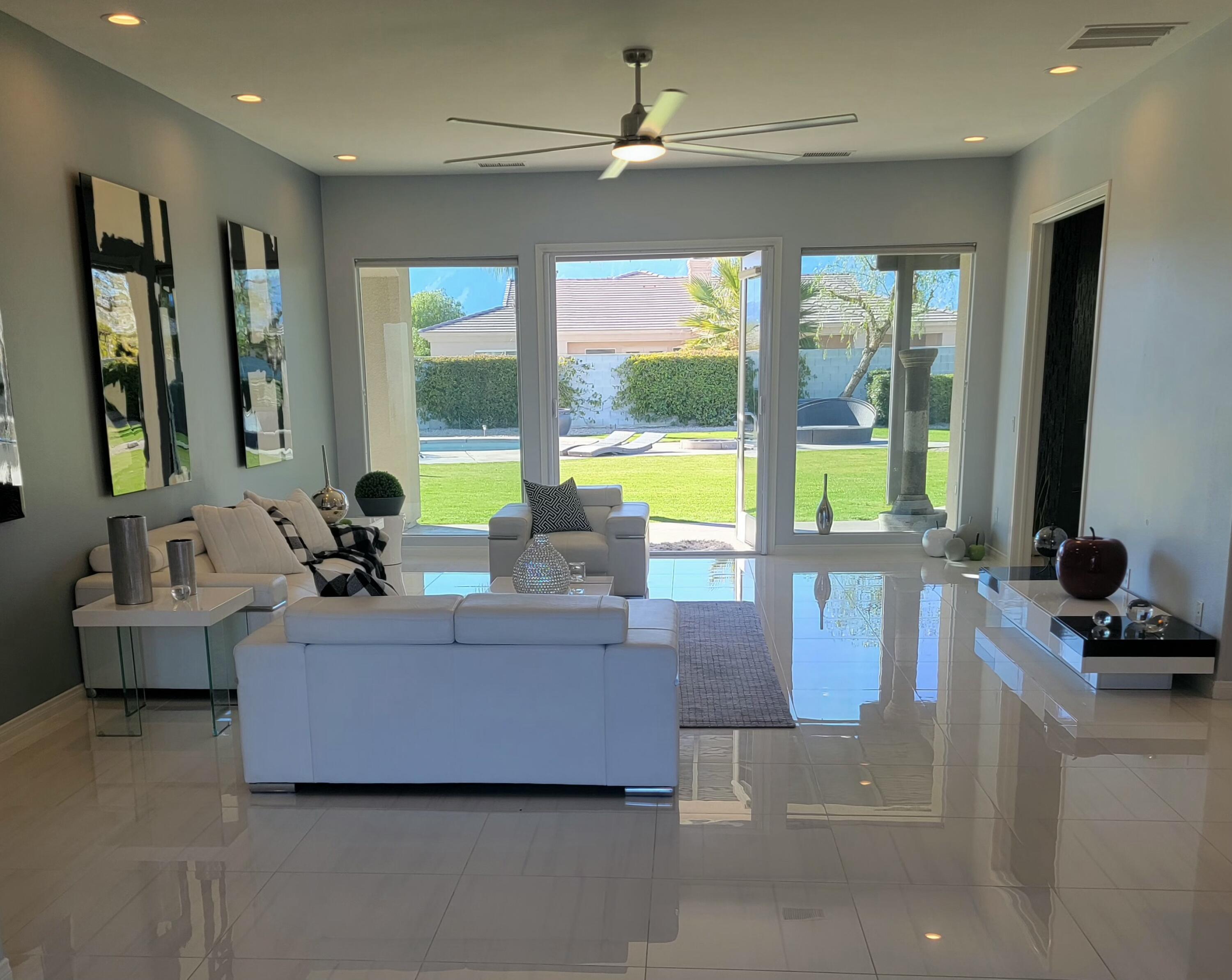 a living room with furniture and a large window