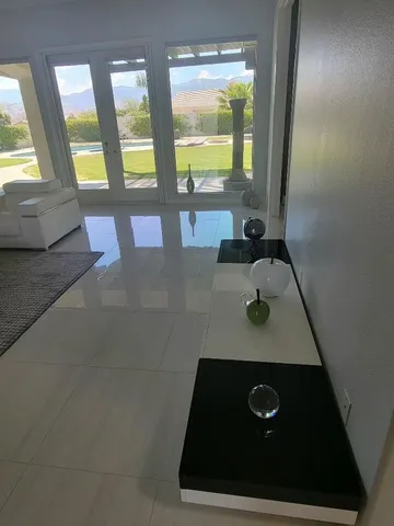 a room with two beds and large windows