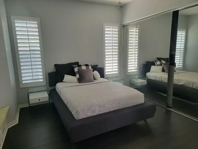 a bedroom with a bed and window