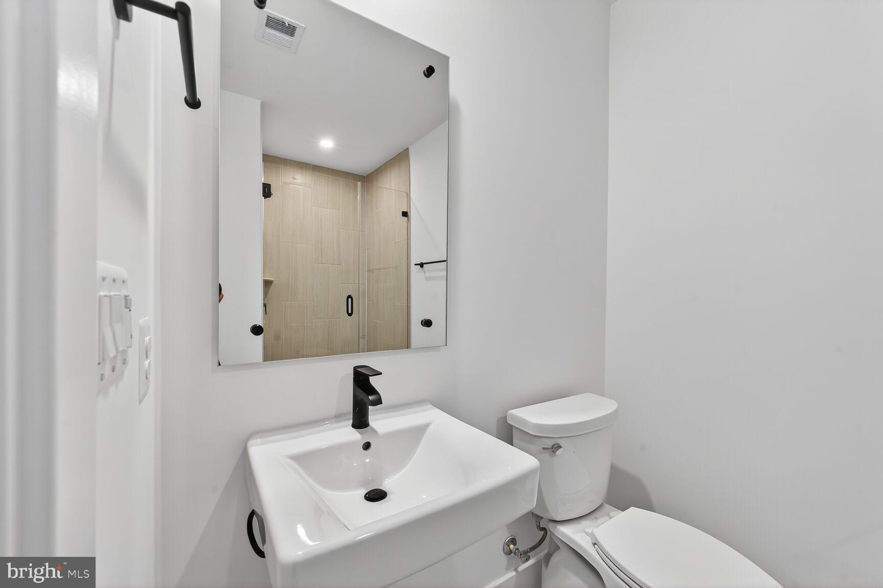 1135 Polaris Road, Unit NOTTINGHAM 101 Potomac, MD 20854 - Photo 14 of 26 a bathroom with a sink a toilet and shower