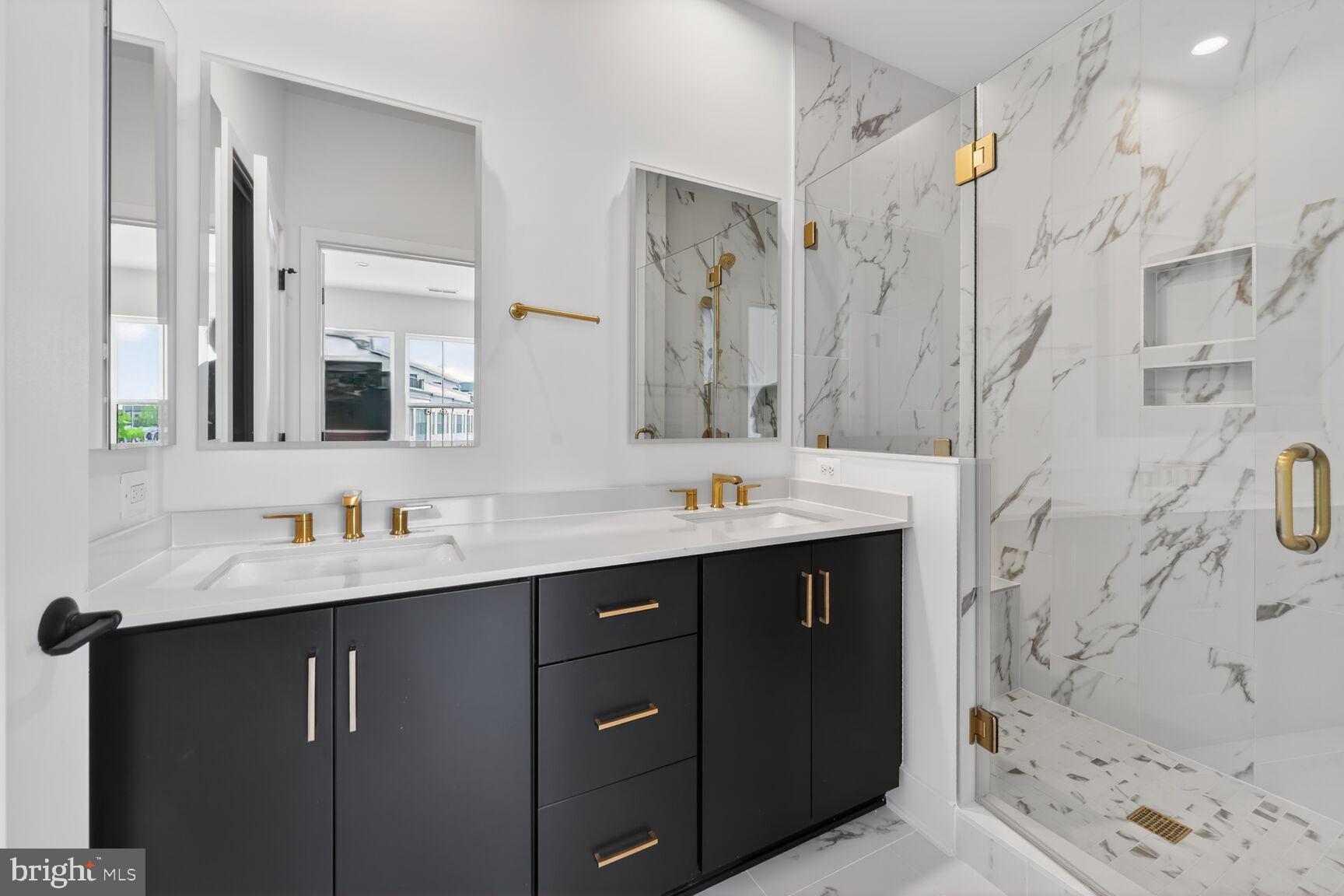 1135 Polaris Road, Unit NOTTINGHAM 101 Potomac, MD 20854 - Photo 17 of 26 a bathroom with a double vanity sink mirror and shower