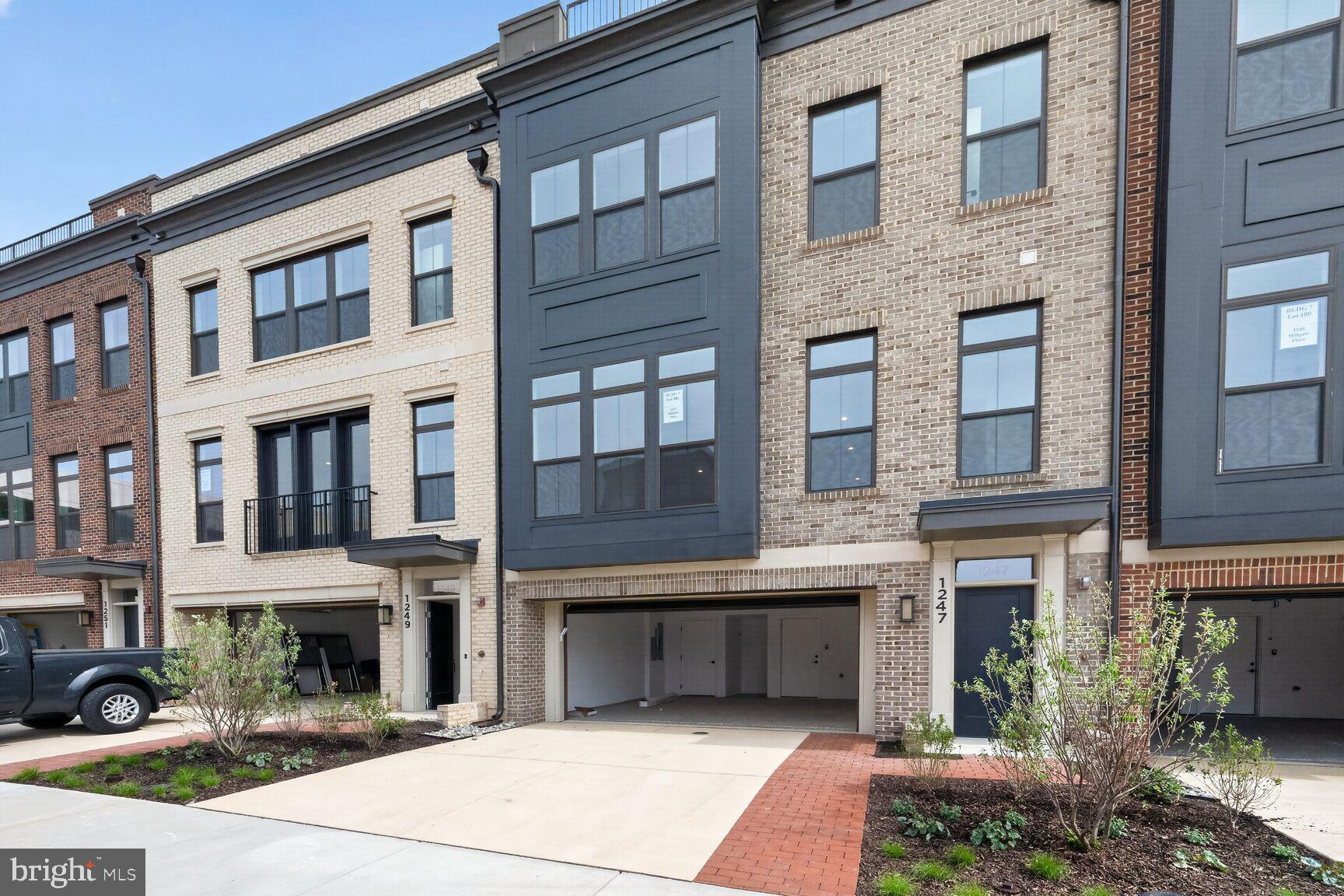 1135 Polaris Road, Unit NOTTINGHAM 101 Potomac, MD 20854 - Photo 2 of 26 a front view of a brick building with many windows