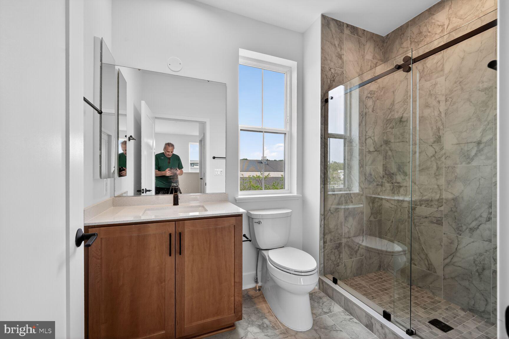1135 Polaris Road, Unit NOTTINGHAM 101 Potomac, MD 20854 - Photo 23 of 26 a bathroom with a sink a toilet and shower
