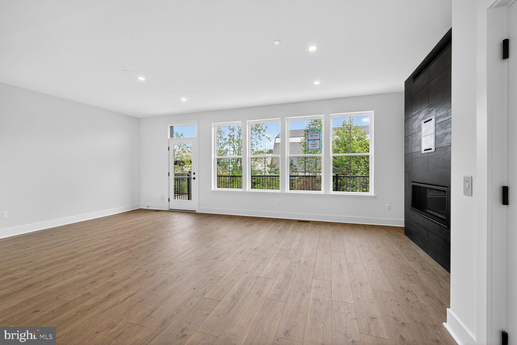 1135 Polaris Road, Unit NOTTINGHAM 101 Potomac, MD 20854 - Photo 6 of 26 wooden floor in an empty room with a window