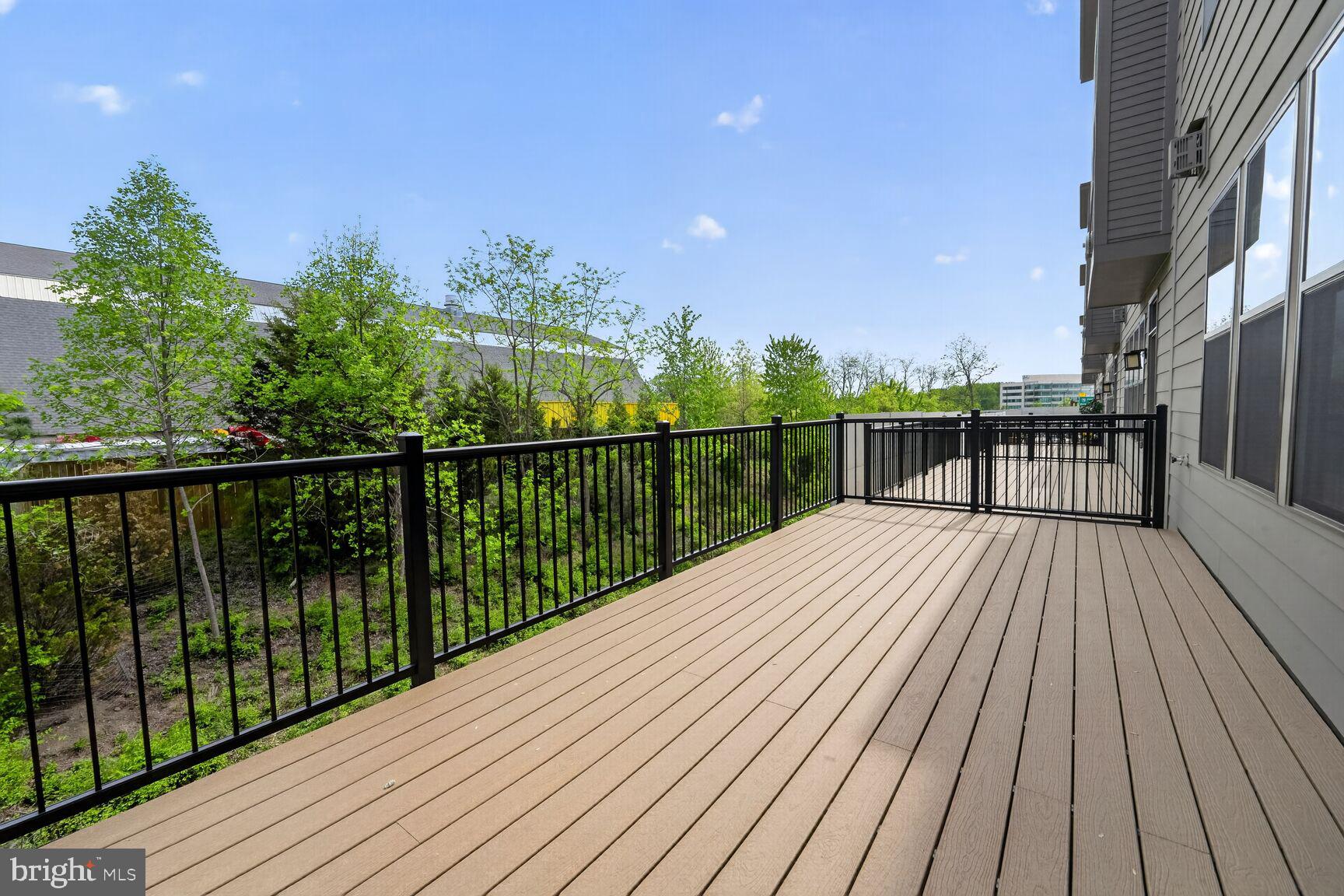1135 Polaris Road, Unit NOTTINGHAM 101 Potomac, MD 20854 - Photo 7 of 26 a view of balcony with wooden floor and fence