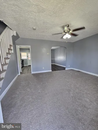 a view of an empty room with a ceiling fan