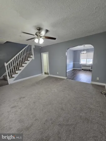 a view of a livingroom with a ceiling fan and window