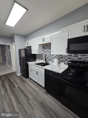 a kitchen with a sink stove and refrigerator