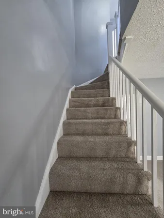 a view of staircase with white walls