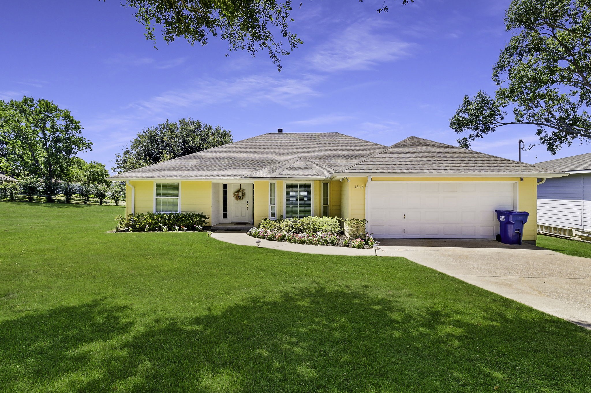 a front view of a house with a garden and porch
